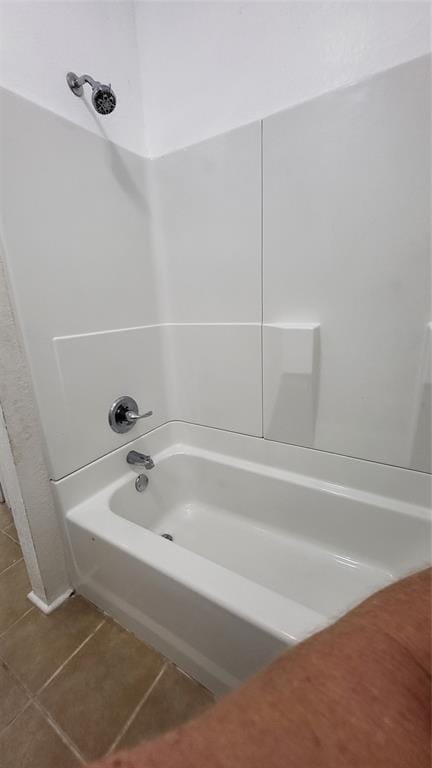 bathroom featuring shower / washtub combination and tile patterned flooring