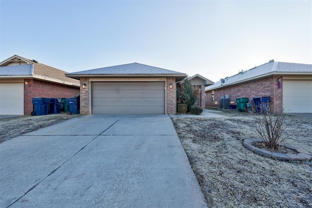 exterior space with a garage and central AC