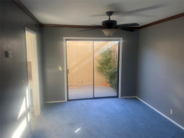 carpeted spare room with ceiling fan and crown molding