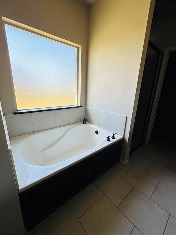 bathroom featuring a tub and tile patterned flooring