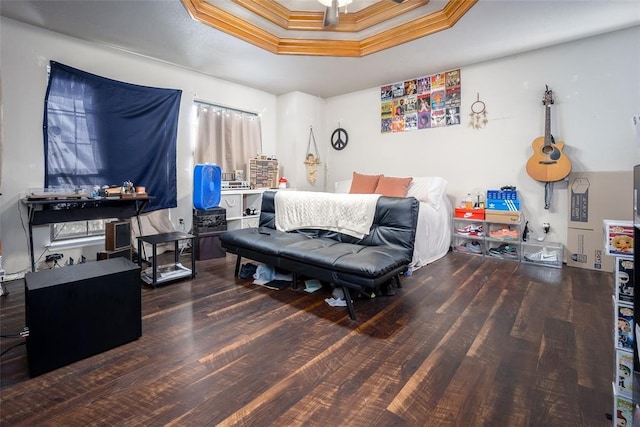 bedroom featuring a tray ceiling, dark hardwood / wood-style flooring, and crown molding