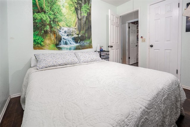 bedroom with dark wood-type flooring