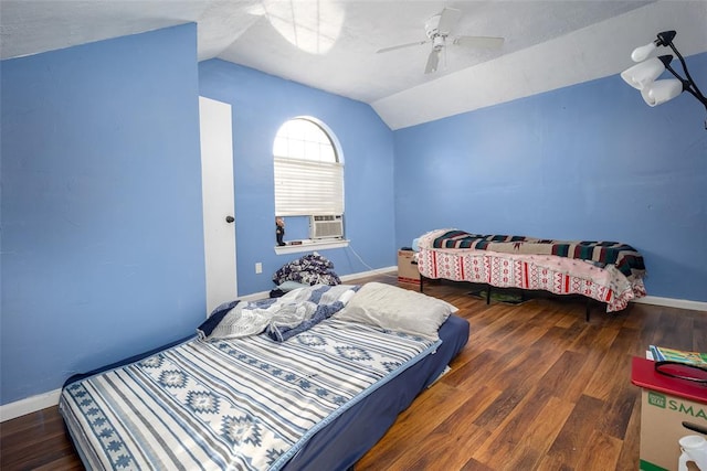 bedroom featuring ceiling fan, vaulted ceiling, dark wood-type flooring, and cooling unit