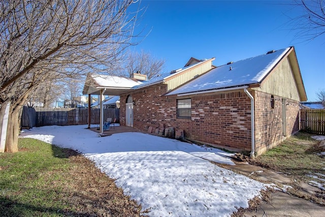 view of snow covered rear of property