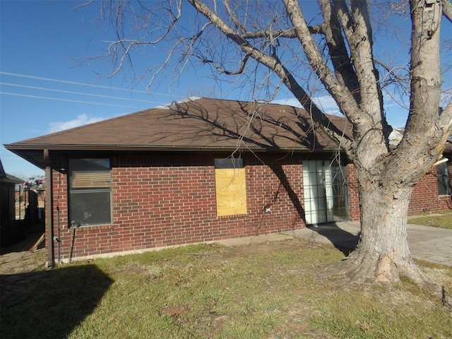 view of side of home featuring a lawn