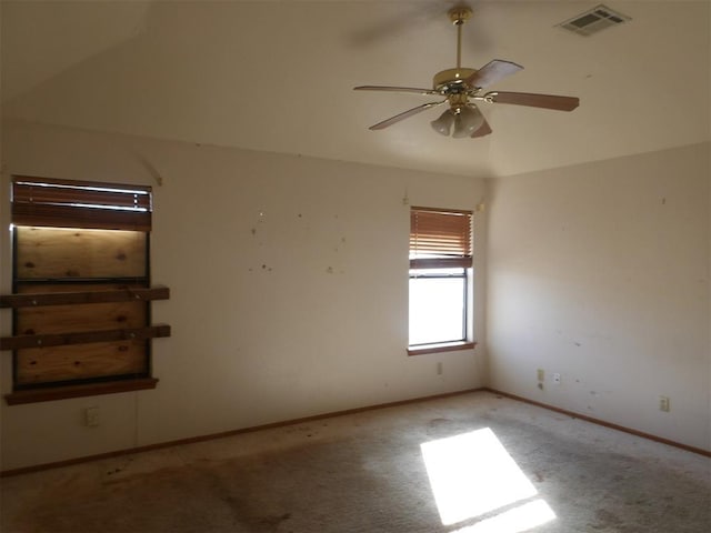 empty room with ceiling fan, light colored carpet, and lofted ceiling