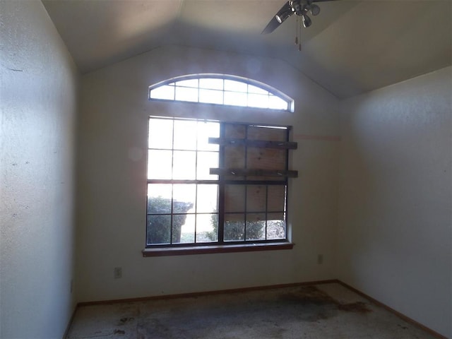 carpeted empty room featuring vaulted ceiling and ceiling fan