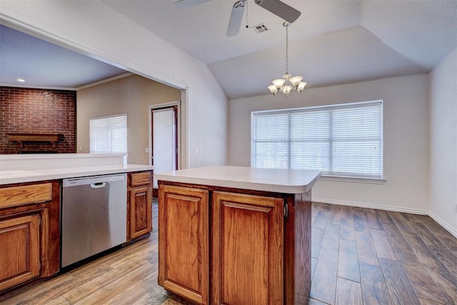 kitchen featuring stainless steel dishwasher, light wood-type flooring, pendant lighting, ceiling fan with notable chandelier, and a center island