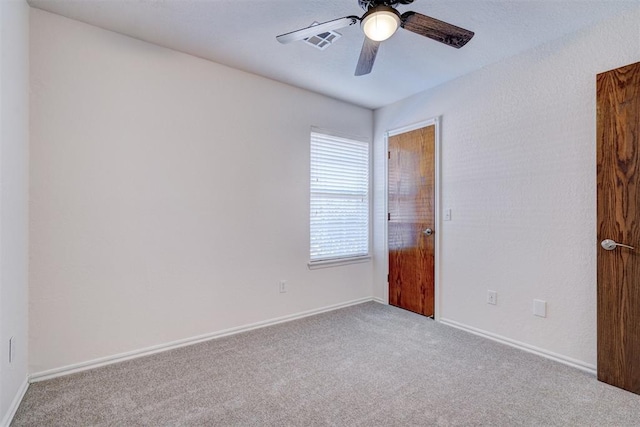 carpeted spare room with ceiling fan