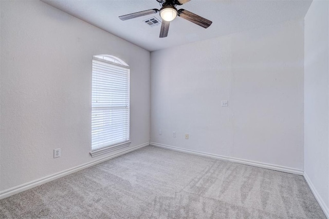 empty room featuring ceiling fan and carpet flooring