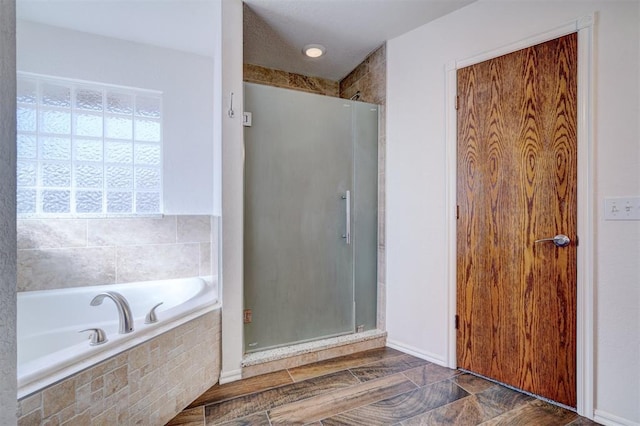 bathroom featuring separate shower and tub