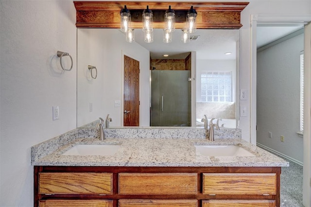 bathroom featuring a shower with door and vanity