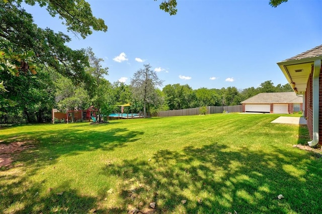 view of yard with a garage and a swimming pool