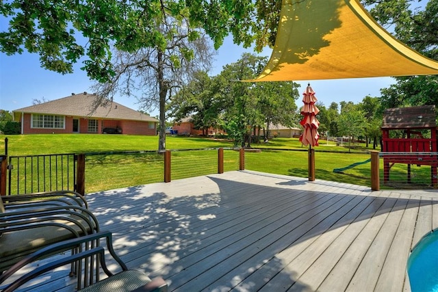 wooden terrace with a playground and a lawn