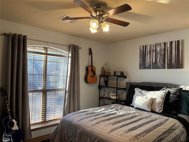 bedroom featuring ceiling fan and multiple windows