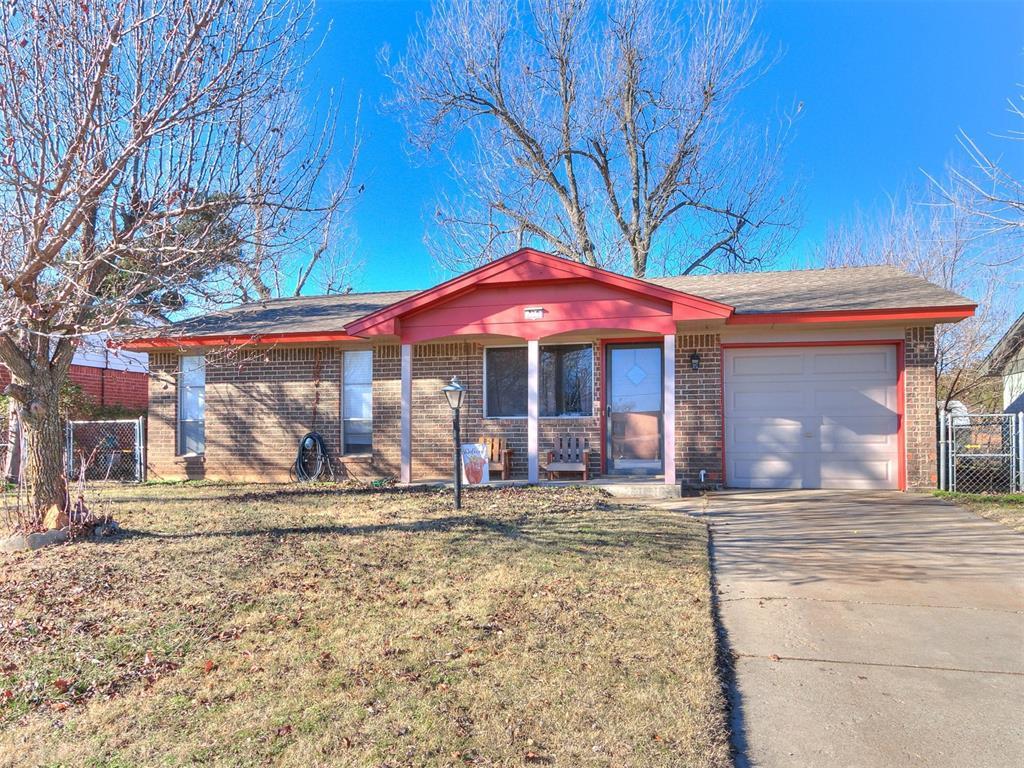 ranch-style home with a front yard and a garage