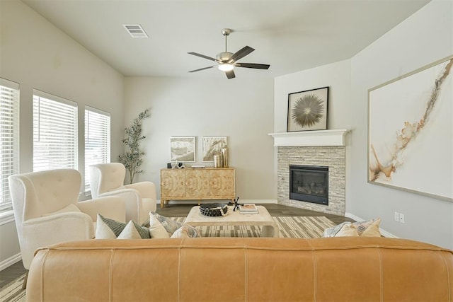 living room featuring ceiling fan, a fireplace, and hardwood / wood-style floors