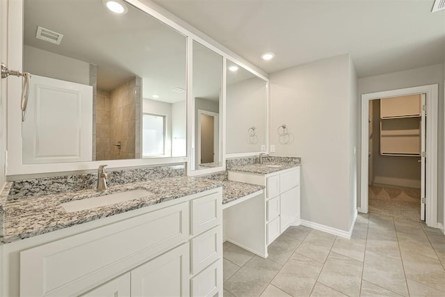 bathroom with vanity, a shower, and tile patterned floors