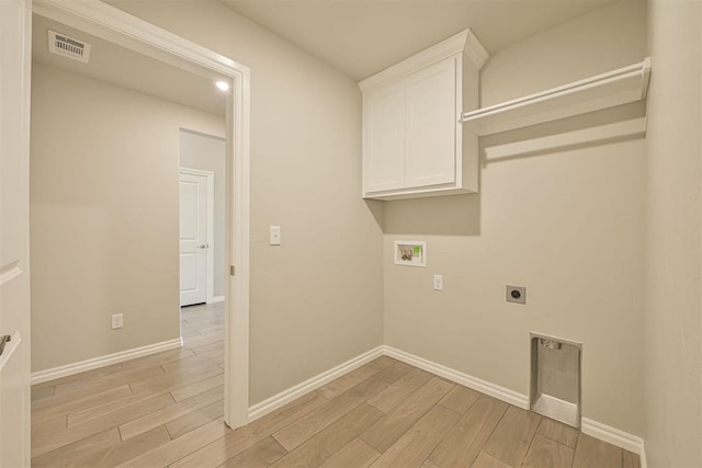 laundry room featuring cabinets, hookup for a washing machine, and hookup for an electric dryer