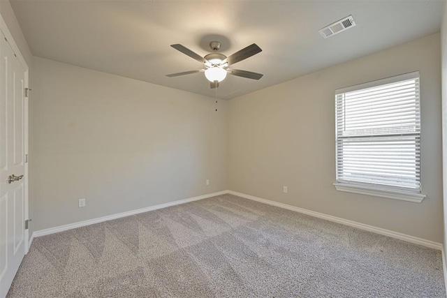 unfurnished room featuring light colored carpet and ceiling fan