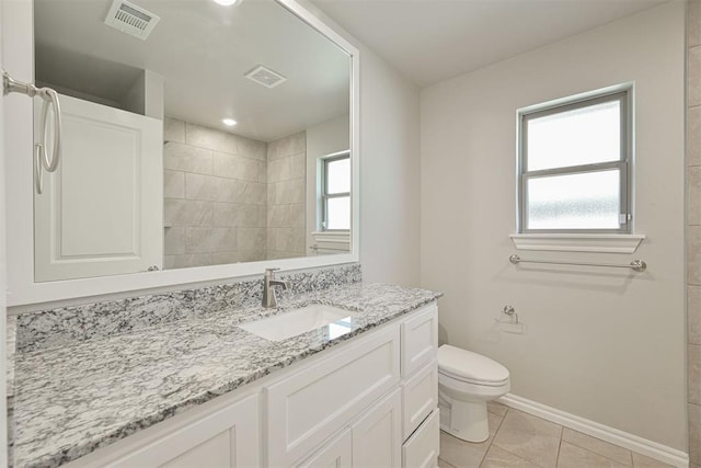 bathroom with vanity, tile patterned floors, and toilet