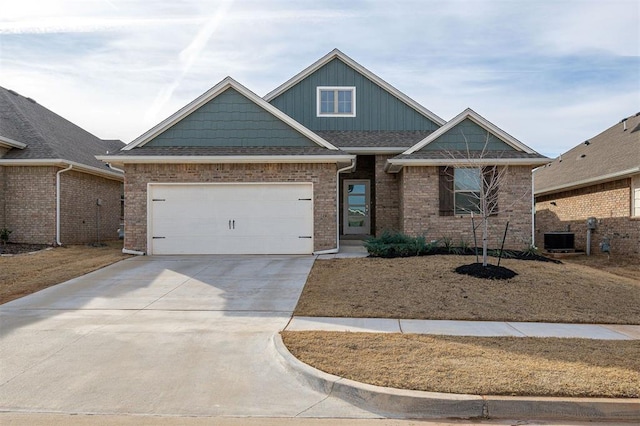 view of front of house featuring a garage and central AC unit