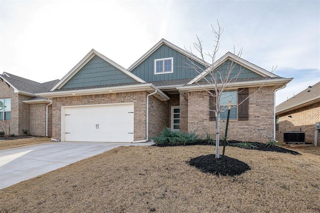 view of front of property featuring central AC and a garage