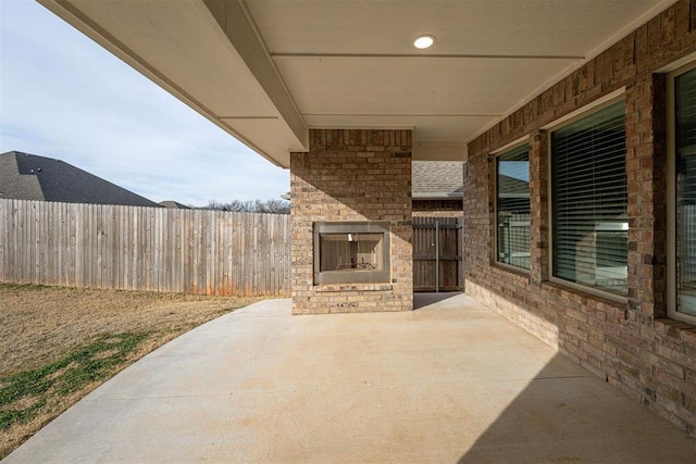 view of patio / terrace with an outdoor brick fireplace