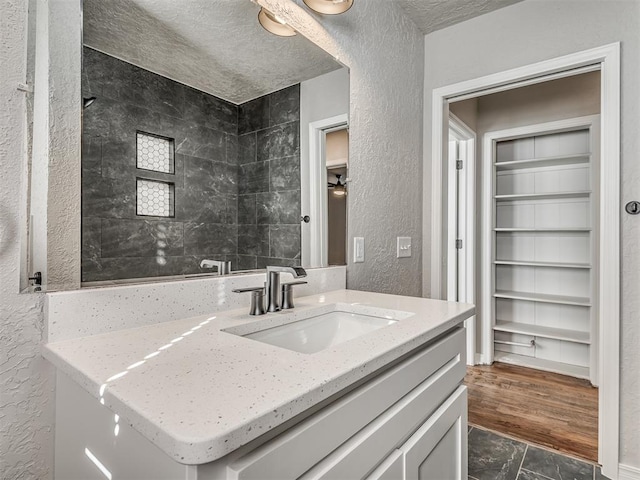 bathroom featuring a textured ceiling and vanity