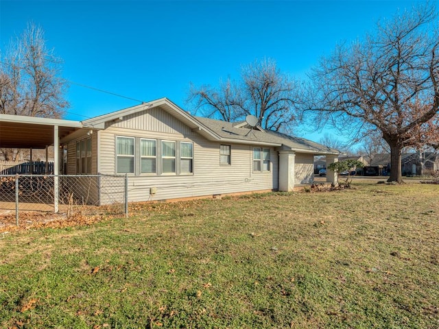 view of property exterior featuring a lawn and a carport