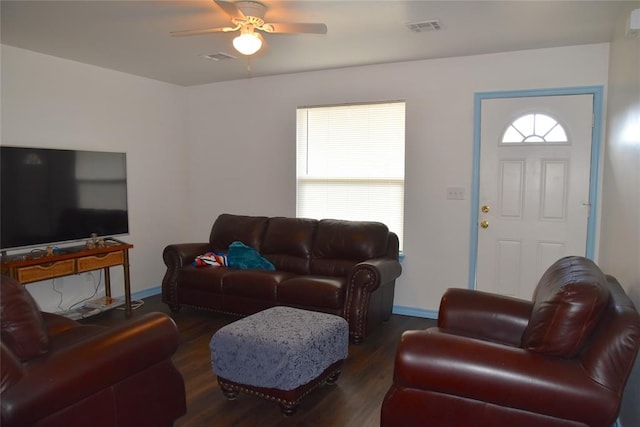 living room featuring ceiling fan and dark hardwood / wood-style flooring