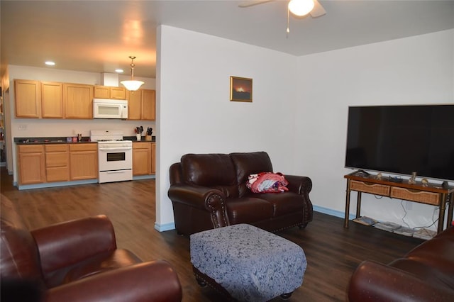 living room featuring dark wood-type flooring and ceiling fan