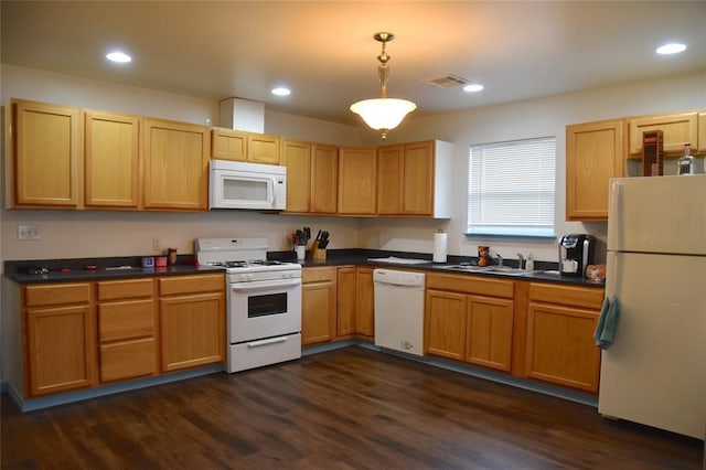 kitchen featuring hanging light fixtures, dark hardwood / wood-style flooring, sink, and white appliances