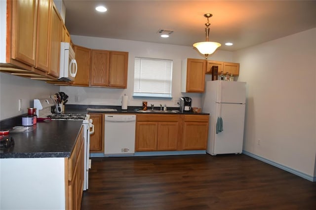 kitchen with hanging light fixtures, dark hardwood / wood-style floors, sink, and white appliances