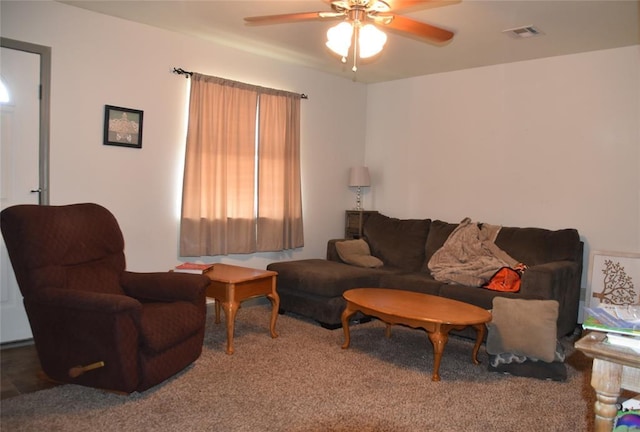 carpeted living room with ceiling fan