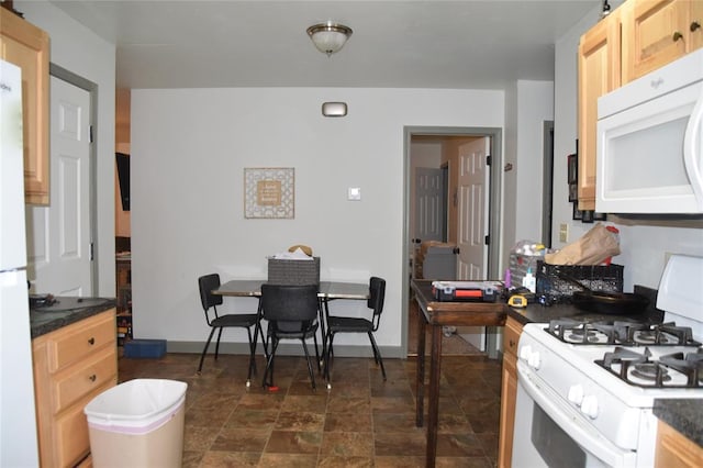 kitchen with light brown cabinets and white appliances