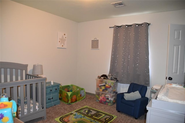 bedroom with carpet floors and a crib