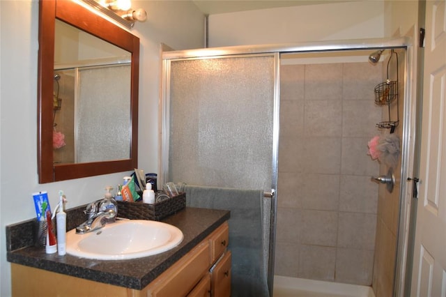 bathroom featuring an enclosed shower and vanity