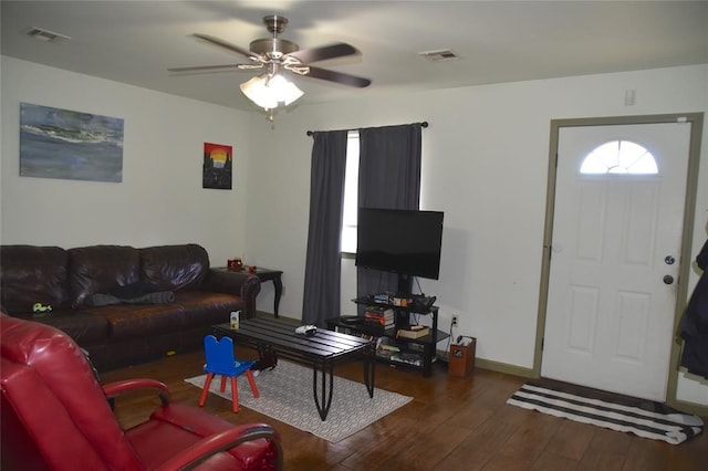 living room featuring ceiling fan and dark hardwood / wood-style flooring