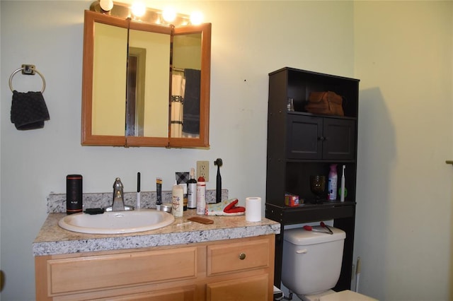 bathroom featuring toilet and vanity