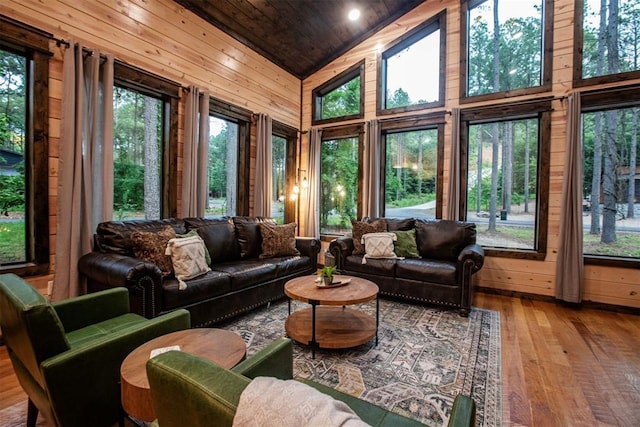 sunroom featuring lofted ceiling and wooden ceiling