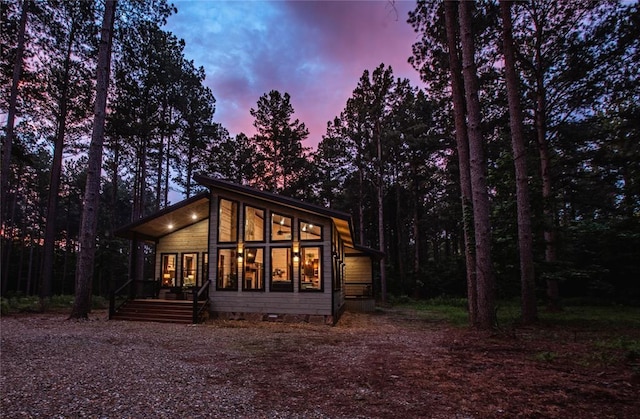 view of back house at dusk