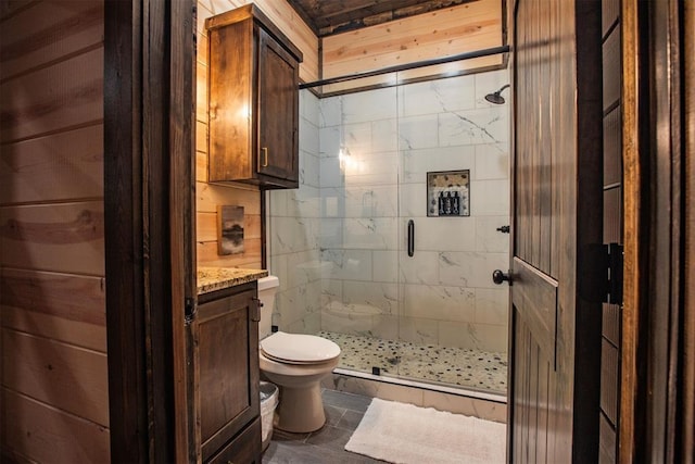 bathroom featuring toilet, a stall shower, and vanity