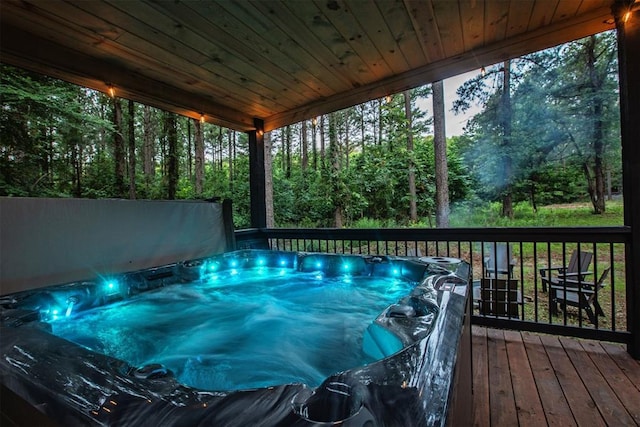 sunroom featuring wooden ceiling, a jacuzzi, and a healthy amount of sunlight