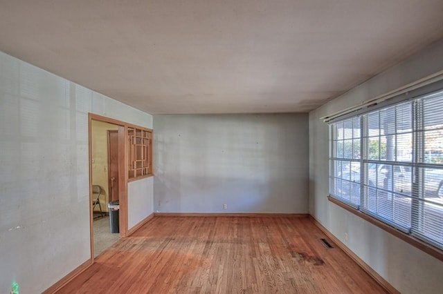 unfurnished room with hardwood / wood-style floors