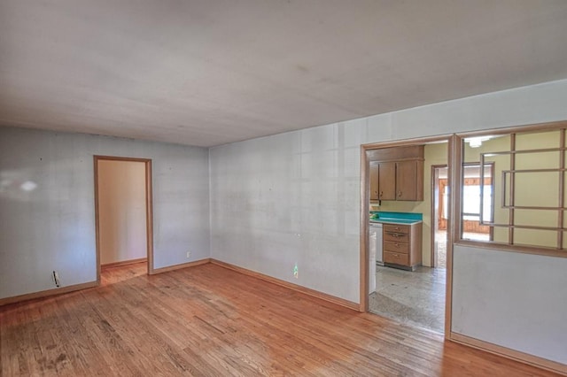 empty room with light hardwood / wood-style flooring