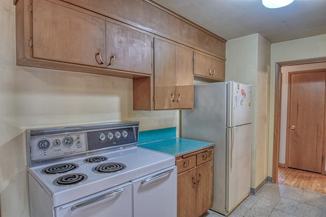 kitchen with stainless steel fridge and white electric range oven