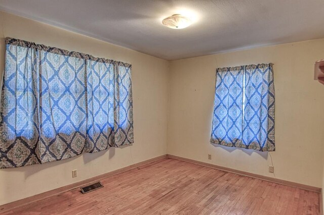 spare room with hardwood / wood-style floors