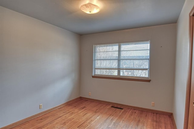 unfurnished room with light hardwood / wood-style flooring