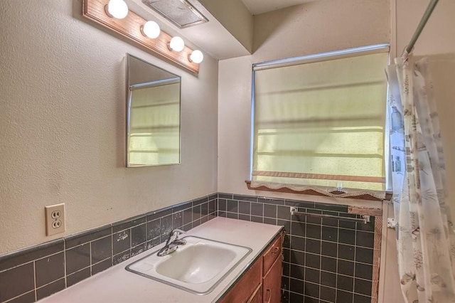 bathroom featuring tile walls and vanity